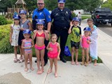 Police officers and a group of kids gathered for National Night Out.