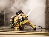 two firefighters spraying water