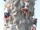 Kids climbing a rock tower