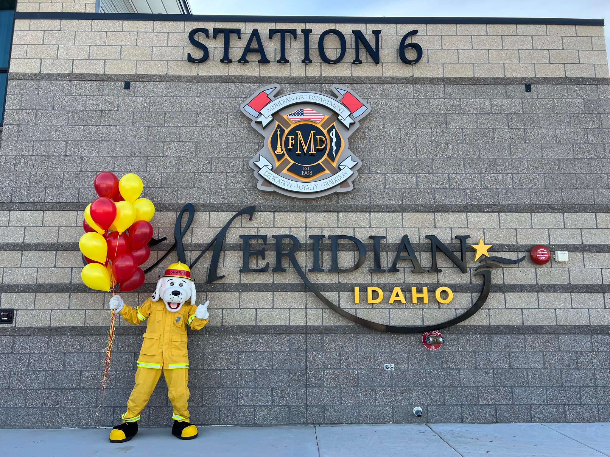 Sparky the Fire Dog Holding Balloons