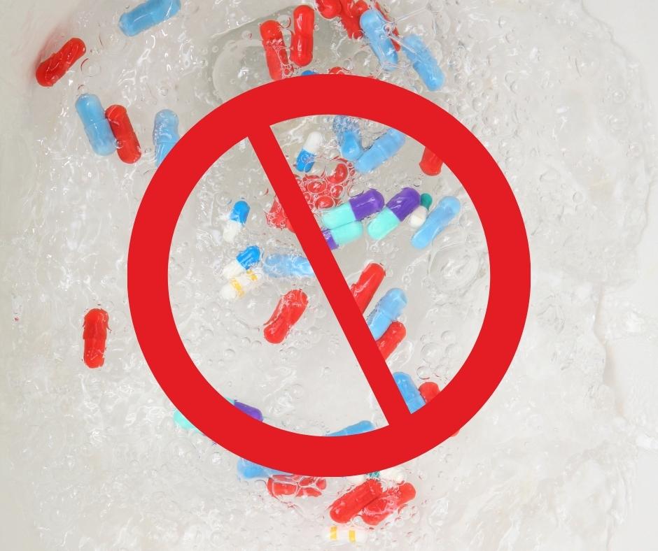 Pharmaceuticals (pills) in a toilet bowl full of water with a "no" symbol (red hollow circle with a line through it) depicts residents should not flush pills