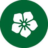 A white flower icon on a dark green background circle