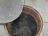 Sanitary sewer with the lid partially removed