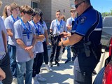 Youth Safety Academy participants circled around a police car and checking out a drone.