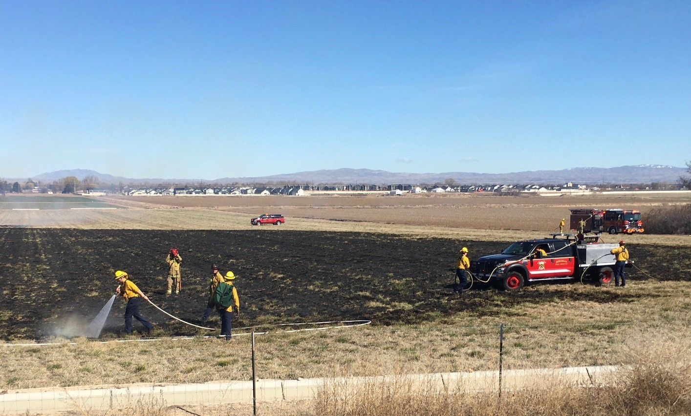 Firefighters stopping a brush fire off of I-84